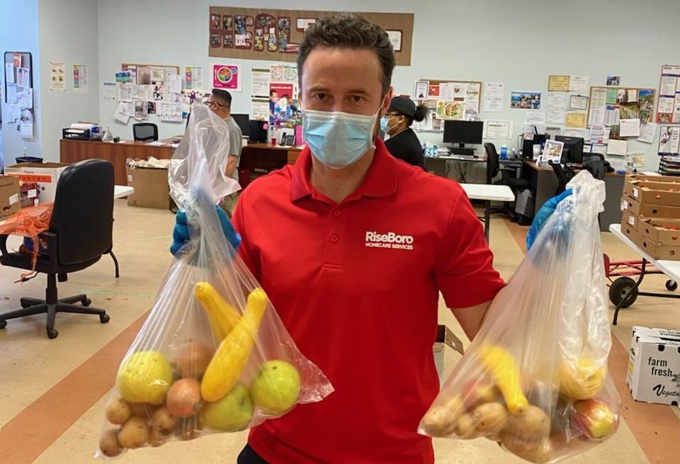 Riseboro CEO Scott Short handing out food at RiseBoro's food pantry in Brooklyn.