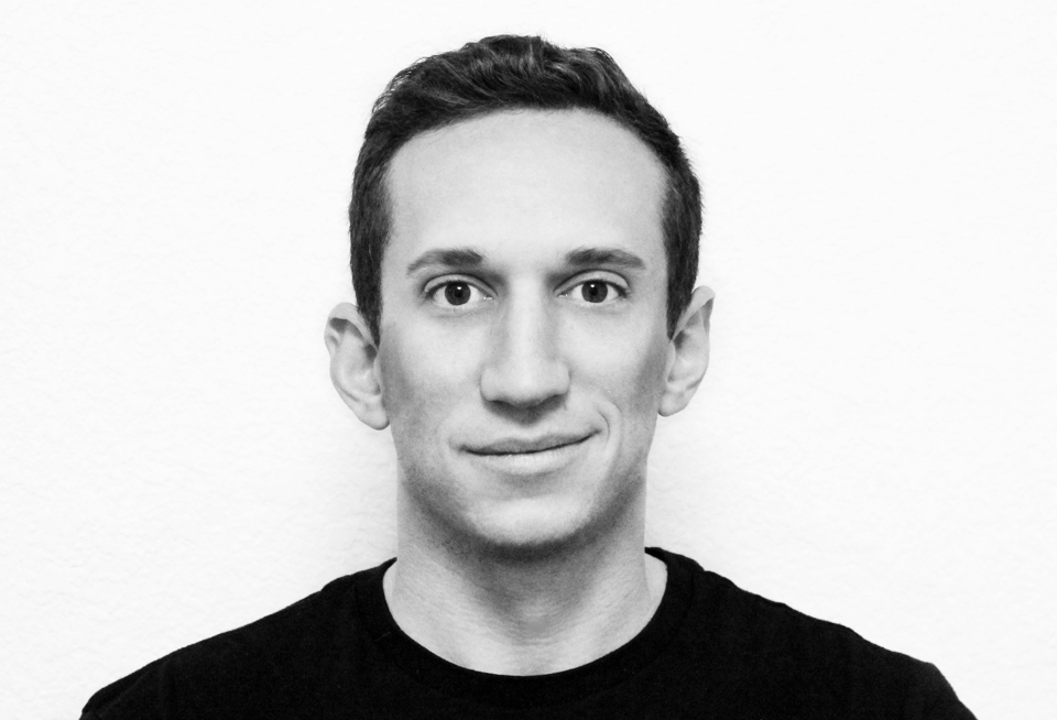 A black and white headshot of Zach Kotel, the executive director of the Lavender Hill Cultural District in Denver