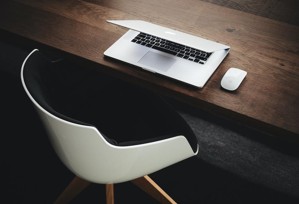 Layoffs - Empty chair with laptop