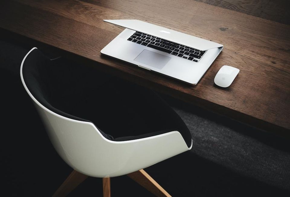 Layoffs - Empty chair with laptop