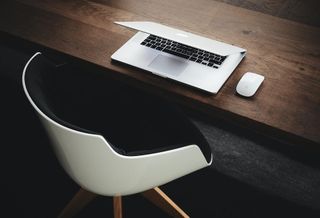 Layoffs - Empty chair with laptop
