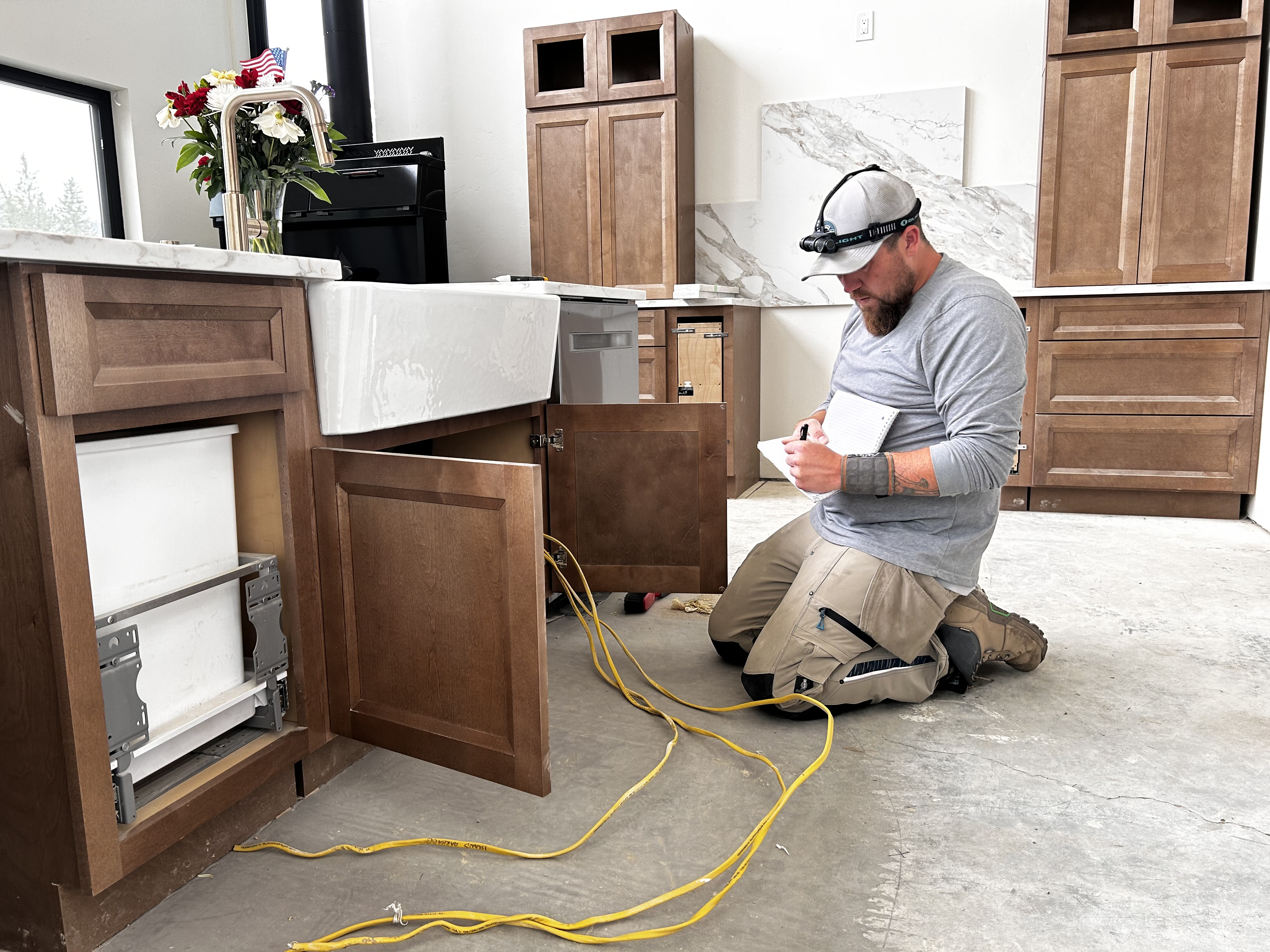 David Engle working on electrical hook-up for the dishwasher.