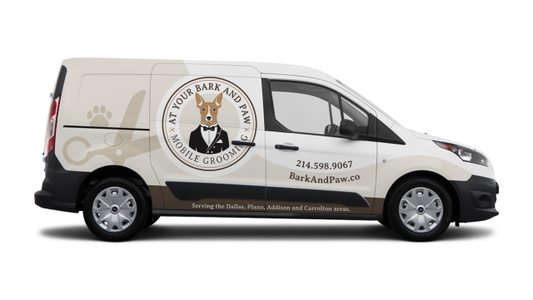 White grooming van with logo of a dog in a tuxedo. Text includes contact number and service areas: Dallas, Plano, Addison, and Carrollton.