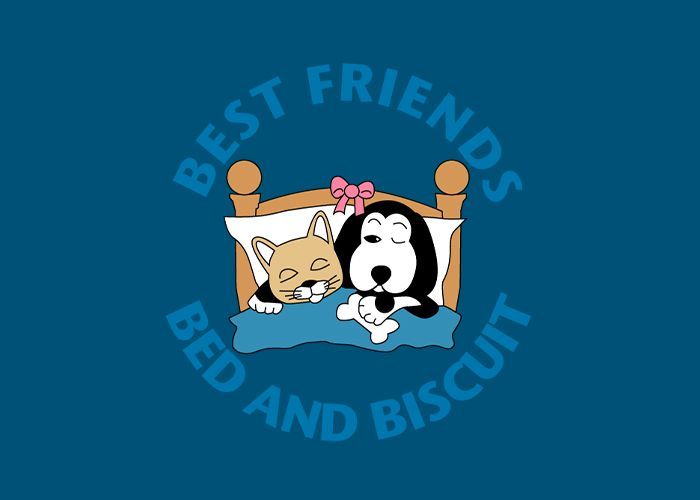 Cartoon cat and dog sleeping together in a bed with "Best Friends Bed and Biscuit" written above and below on a blue background.