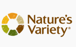 Logo of Nature's Variety with a circular design made of colored segments in orange, yellow, and green, and brown text on a white background.