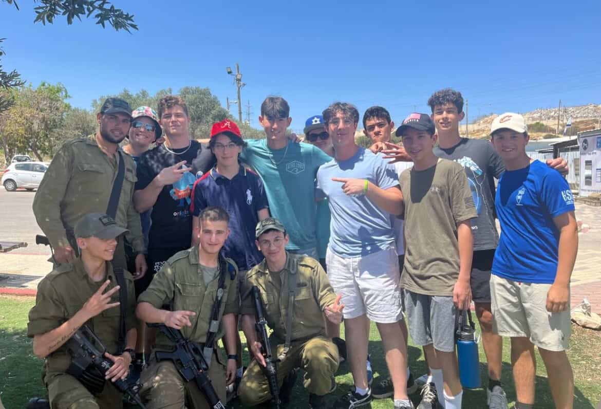 Participants in the Jewish National Fund-USA teen volunteer in Israel mission pose with Israel Defense Forces soldiers in the Negev. Credit: Courtesy.