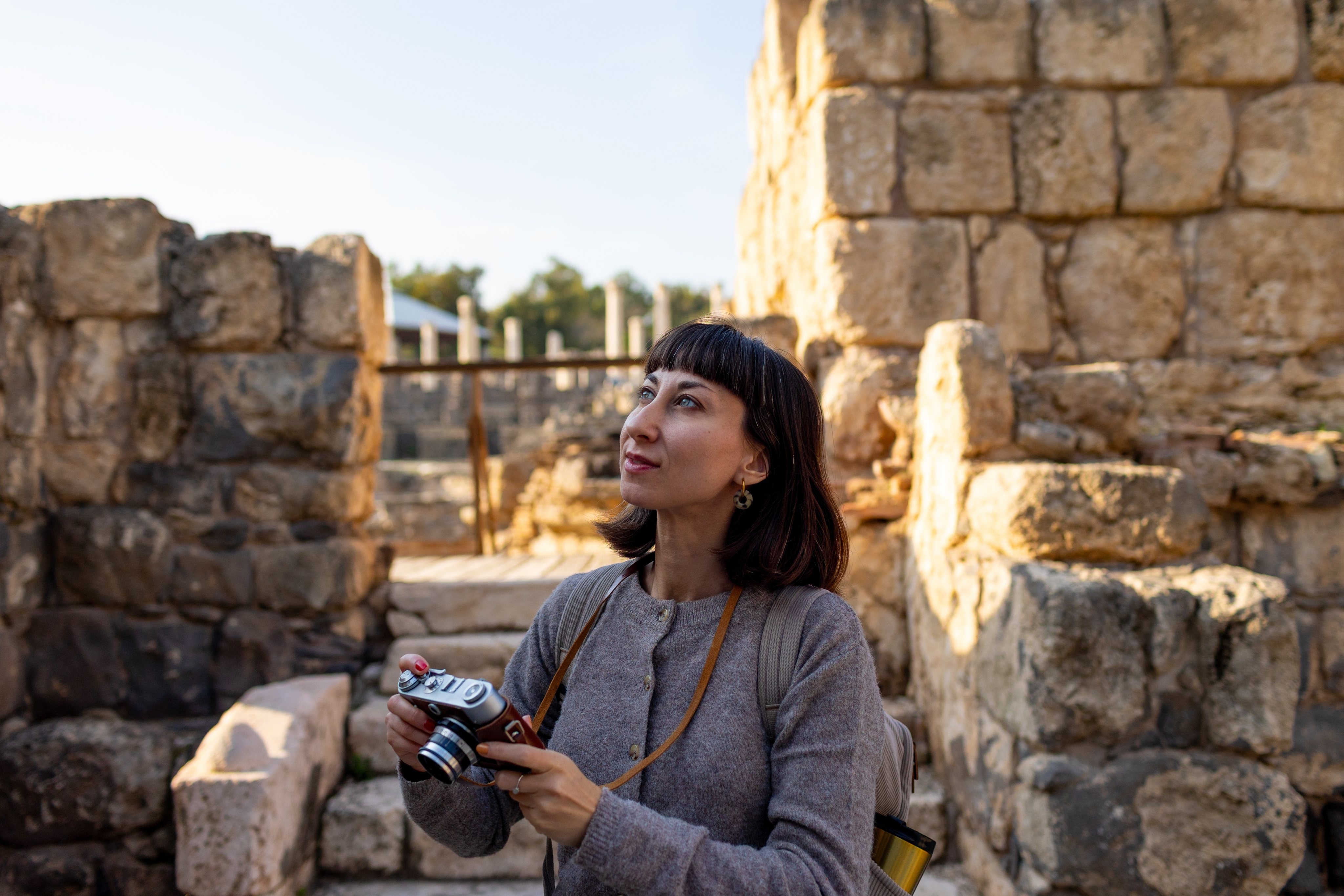 A student photographing ancient ruins in Israel
