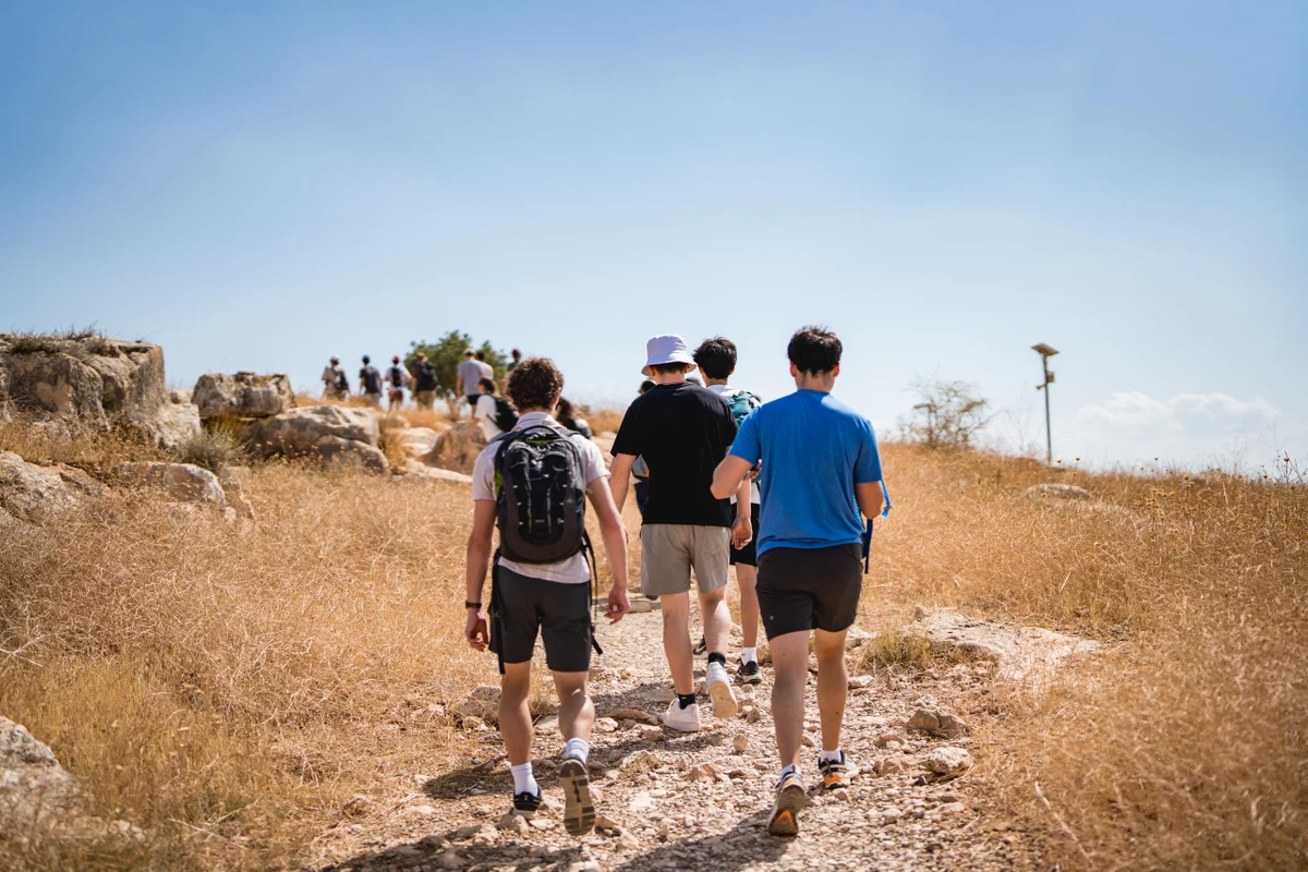 Muss students hiking along a rocky trail in northern Israel