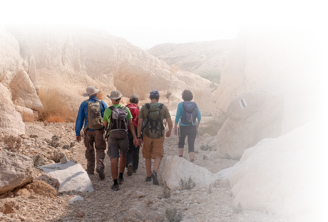 Students hiking together through a desert canyon in Israel