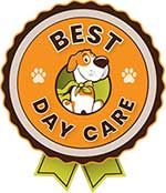 A circular award badge with scalloped dark brown edges and a green ribbon banner at the bottom. The center features an orange ring with white paw prints and the arched text "BEST DAY CARE" in bold black lettering. In the inner green circle sits a cartoon white and brown dog wearing a green cape and neck scarf