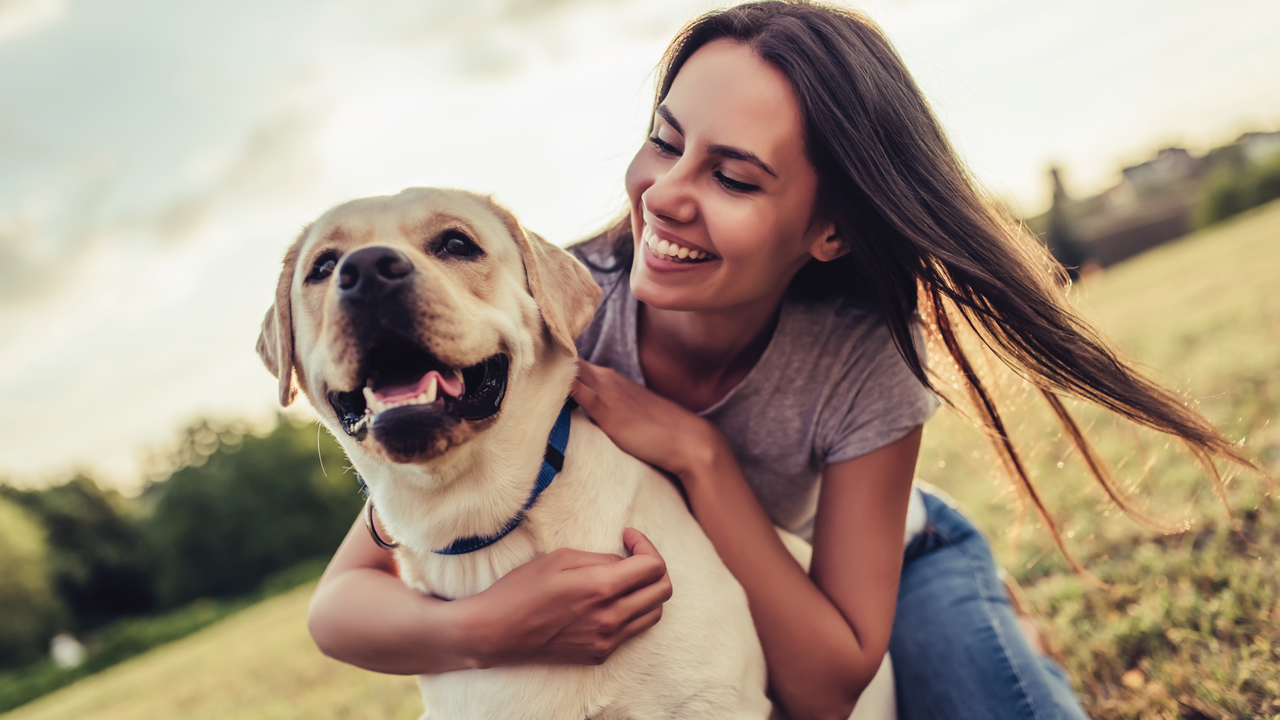Woman hugging yellow lab