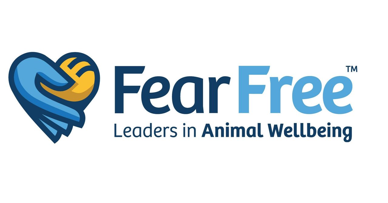 Fear Free logo featuring a heart formed by a blue hand holding a yellow paw print, next to the text "Fear Free: Leaders in Animal Wellbeing